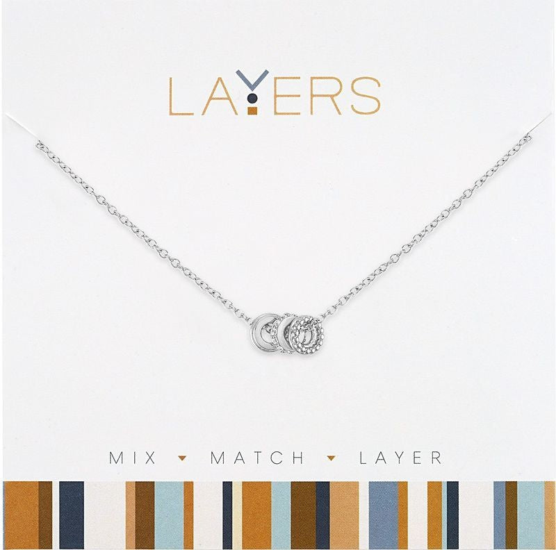 Silver layered necklace with three distinct charms on delicate chains
