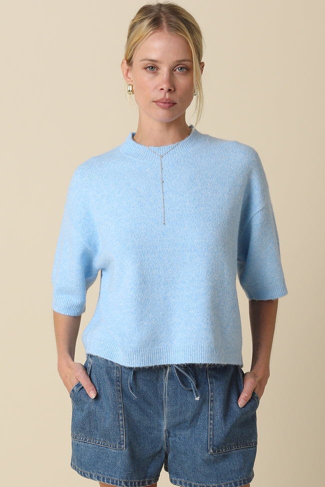 Alice Parker half-sleeve sweater in a neutral tone with a relaxed silhouette.