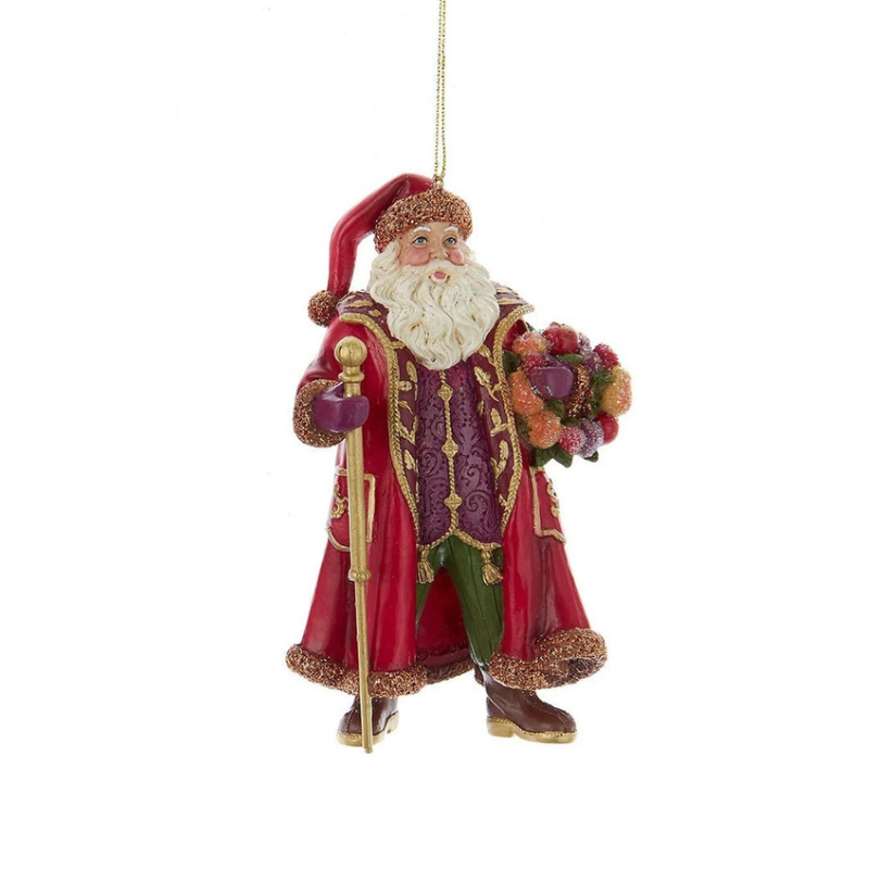 Sugar Frost Santa ornament in a red coat holding a gold staff and a basket of colorful fruit.