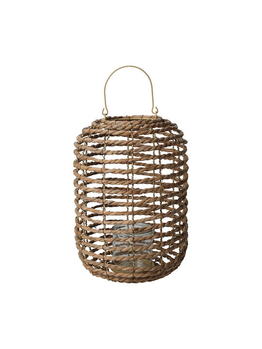 Hand-woven natural cattail leaf lantern with metal frame holding a candle inside.