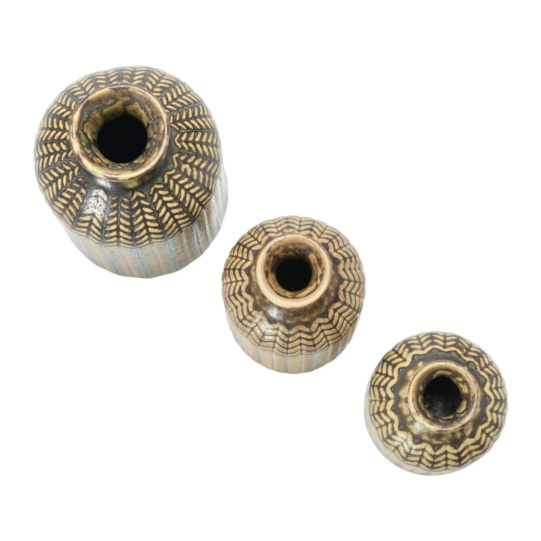 Top view of three round embossed stoneware vases with reactive glaze and textured patterns.
