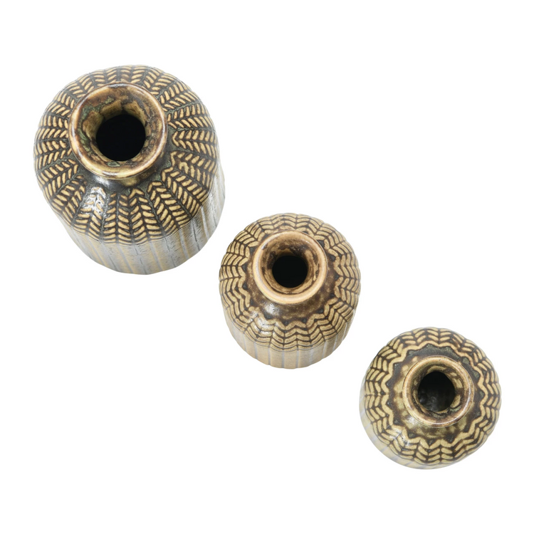 Top view of three round embossed stoneware vases with reactive glaze and textured patterns.