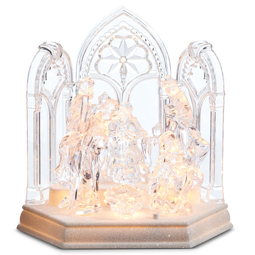 8-inch lighted clear plastic nativity scene with a gothic arch backdrop on a glittery base.