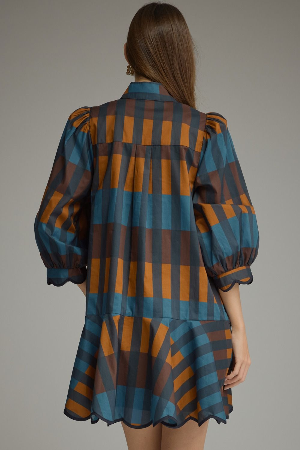 Back view of a woman wearing the Harper Plaid ¾ Balloon Sleeve Mini Dress in blue and orange.