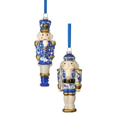Two 6.5-inch glass toy soldier ornaments with blue and white floral patterns and gold accents.