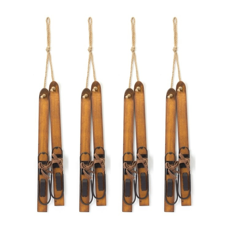 Wooden ski-shaped ornament with natural finish hanging on a Christmas tree.