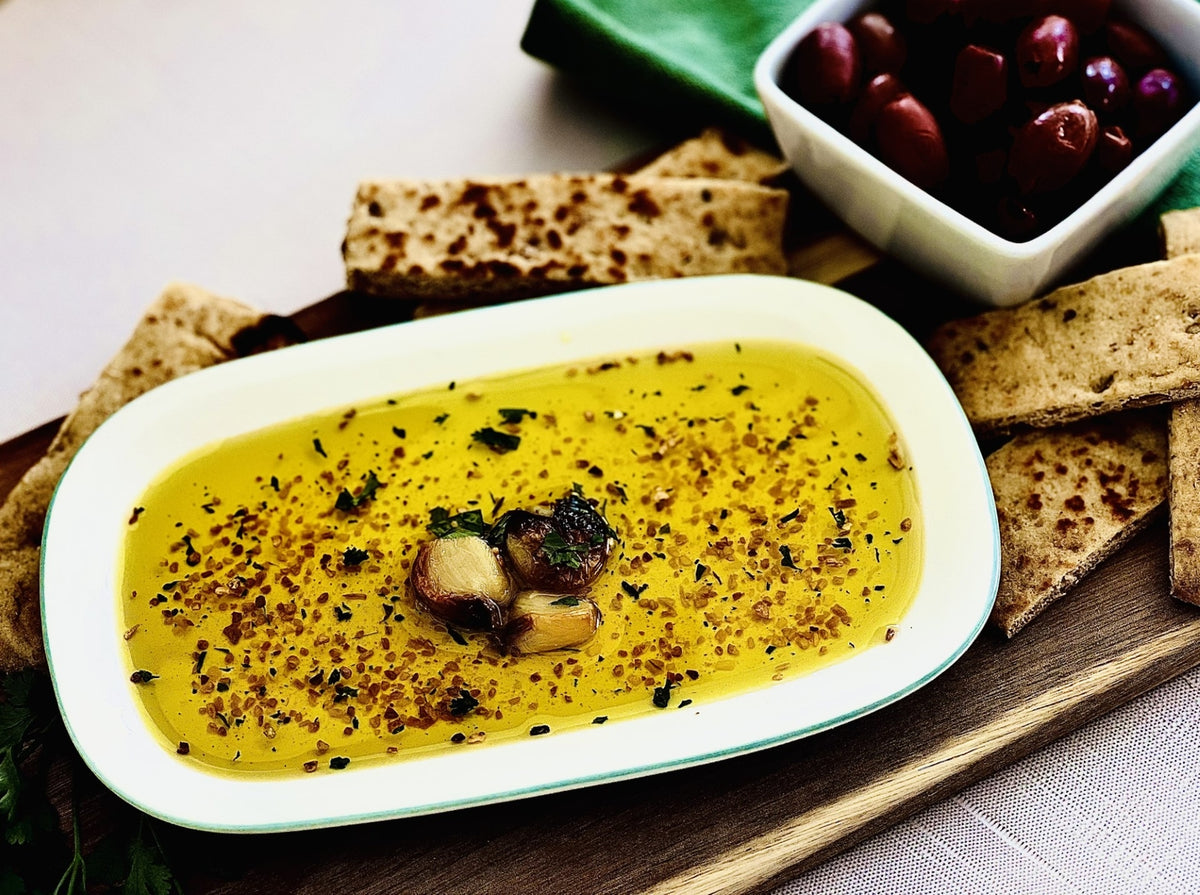 Bottle of toasted garlic dipping oil seasoning with a white label.