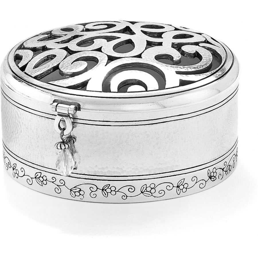 Silver hammered round trinket box with a scribble art scrolled pattern on top.