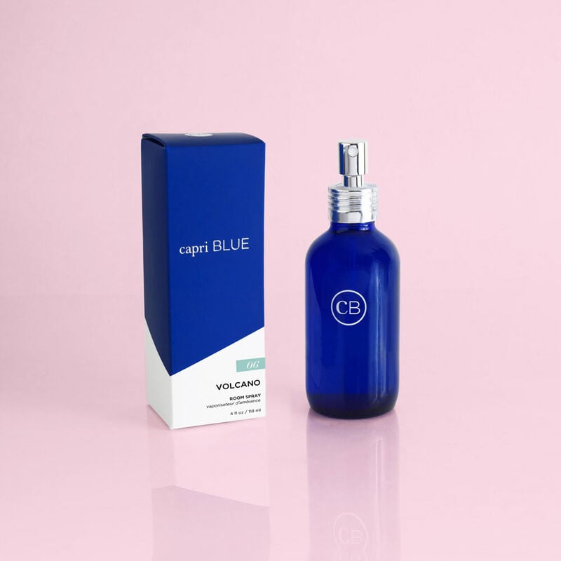 Capri Blue Volcano Signature Room Spray in a blue glass bottle next to its blue and white box.