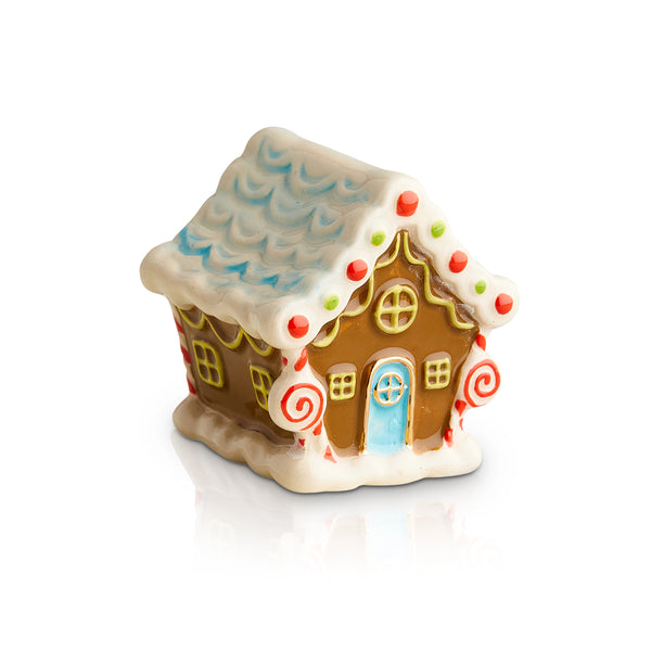 Brown ceramic gingerbread house with blue door, white icing trim, and candy decorations.