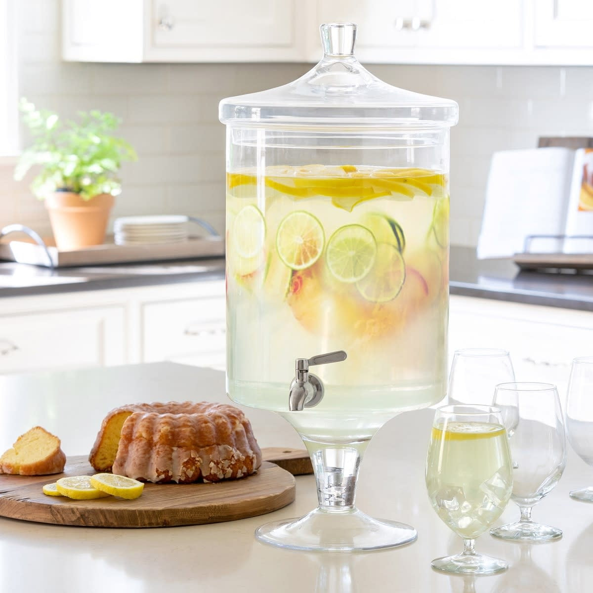Clear crystal beverage dispenser with a sleek cylindrical shape.