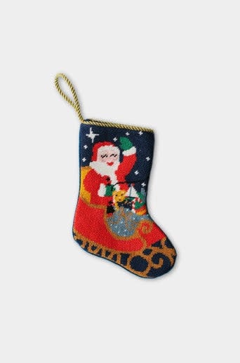 Hand-stitched needlepoint stocking with red sleigh ride Santa pattern on velvet backing