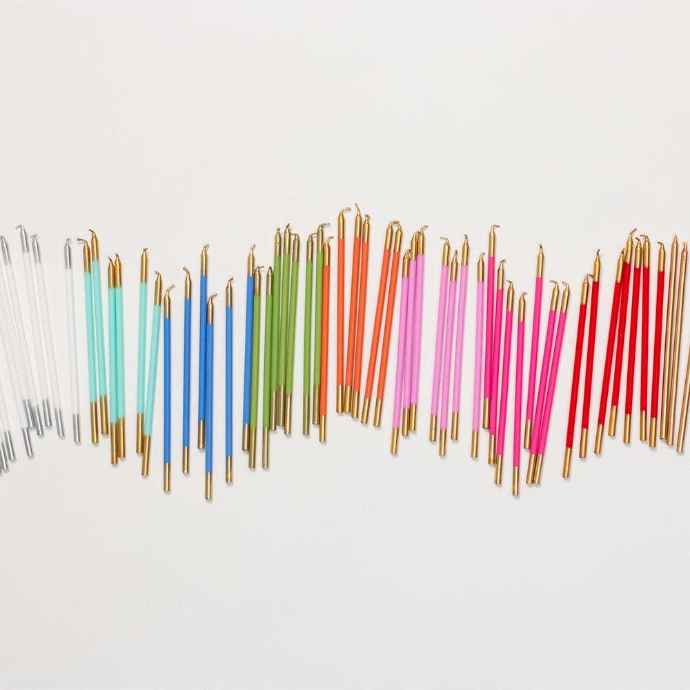 Set of six slim birthday candles in assorted colors from the Caspari palette.