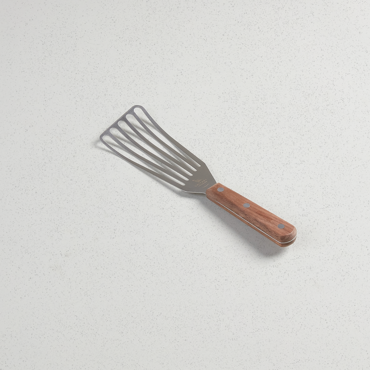 Slotted spatula with full tang walnut handle and durable stainless steel blade.