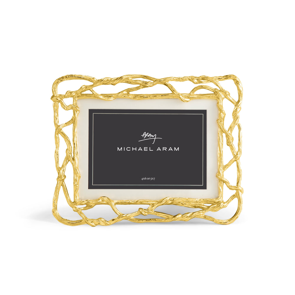 Goldtone rectangular picture frame holding a photo with wisteria floral pattern