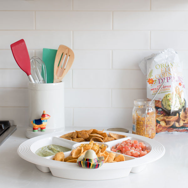 Pinstripes Melamine Divided Dish on a counter filled with chips, salsa, and guacamole.