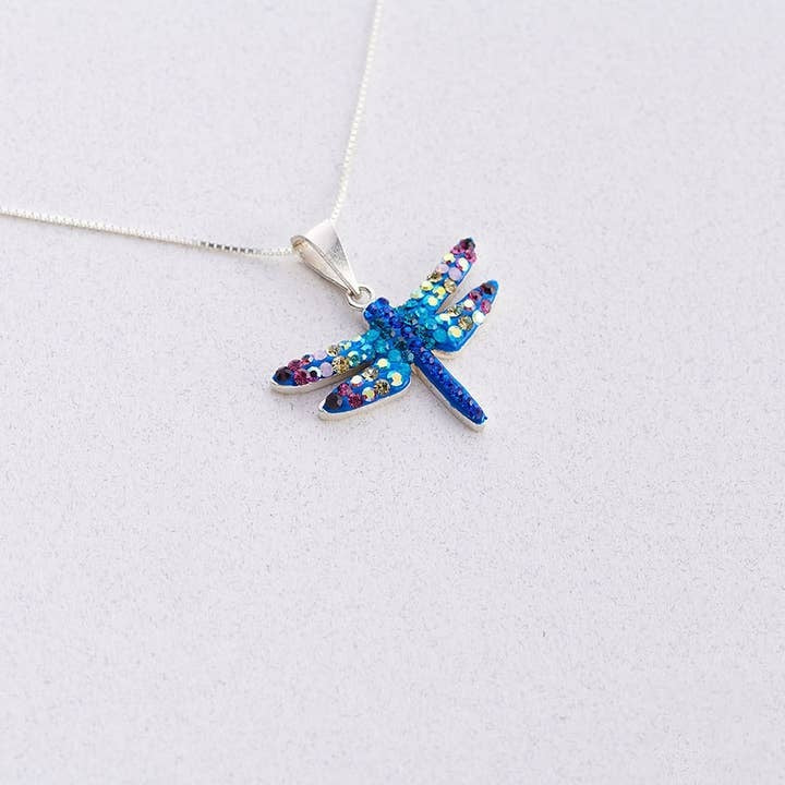 Small sterling silver pendant necklace featuring a purple and blue dragonfly silhouette encrusted with Austrian crystals.