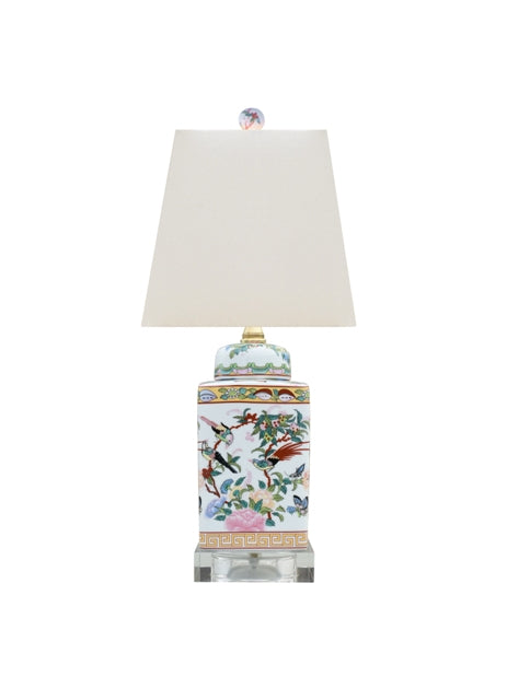 Square porcelain tea jar lamp with crystal base, off-white hardback shade, and drum silhouette.