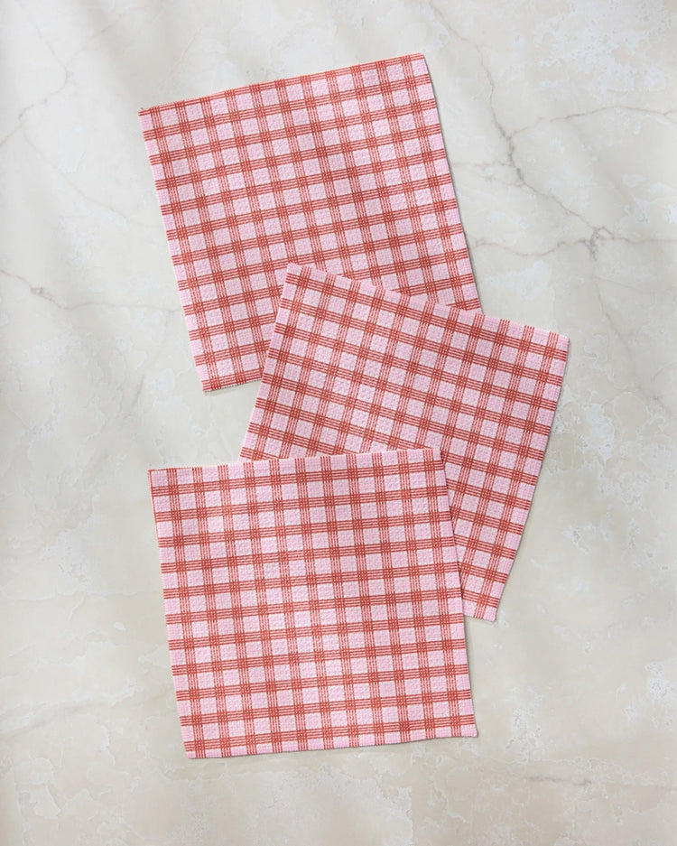 Set of three waffle weave dishcloths in recycled polyester with single-sided prints and hang loops.