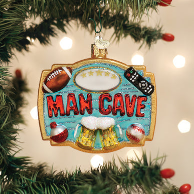 Glass Man Cave ornament featuring a football, remote, beer mugs, and baseball on a blue background.