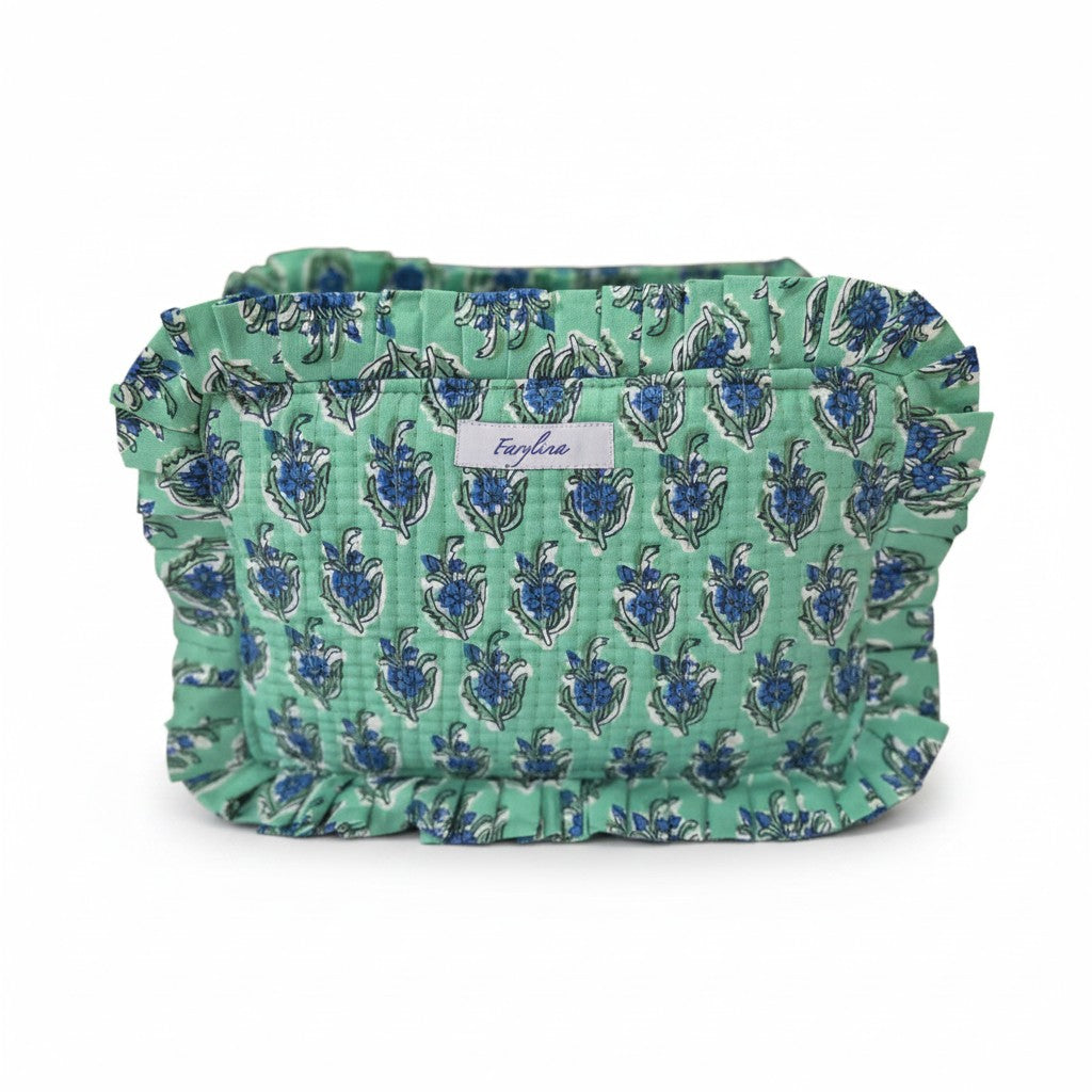 Teal frilly toiletry bag with a blue floral block print pattern and a white Farylina brand label.
