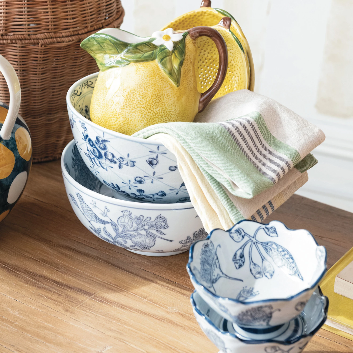 Stacked round porcelain bowls with blue floral patterns and a crackle glaze finish on a wood table.