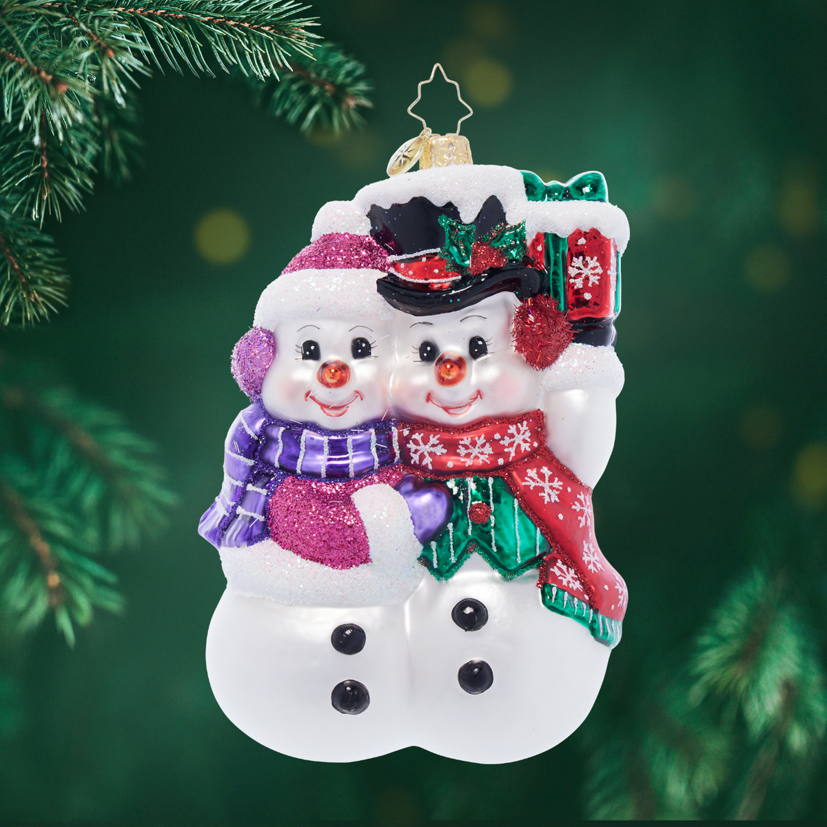 Snow Couple ornament: white resin figurine showing two stylized figures holding hands with snowflake accents.