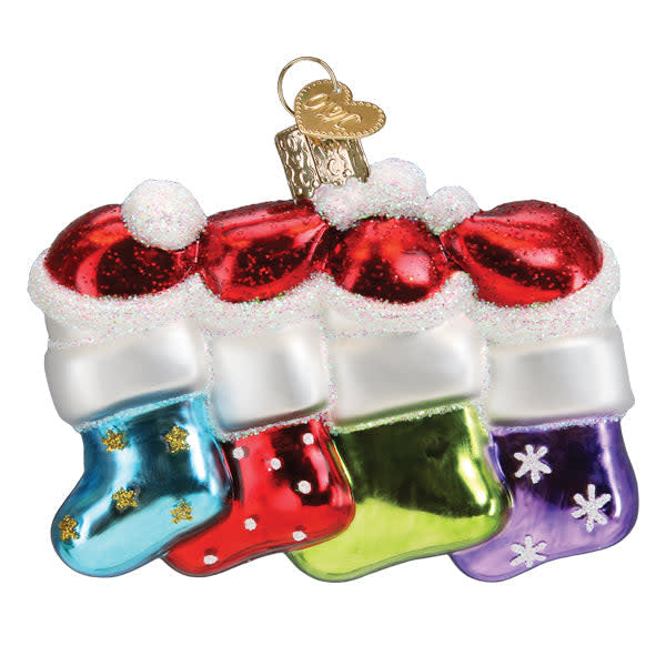 Snow Family Of 4 Ornament featuring four stylized figures in white snow texture with red accents against a dark background.