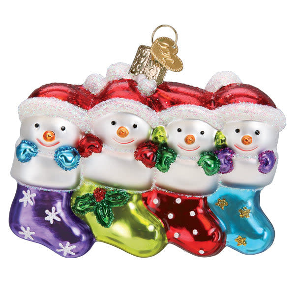 Snow Family Of 4 Ornament featuring four stylized figures in white snow texture with red accents against a dark background.