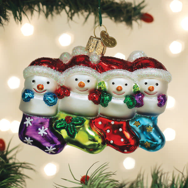 Snow Family Of 4 Ornament featuring four stylized figures in white snow texture with a festive silhouette.
