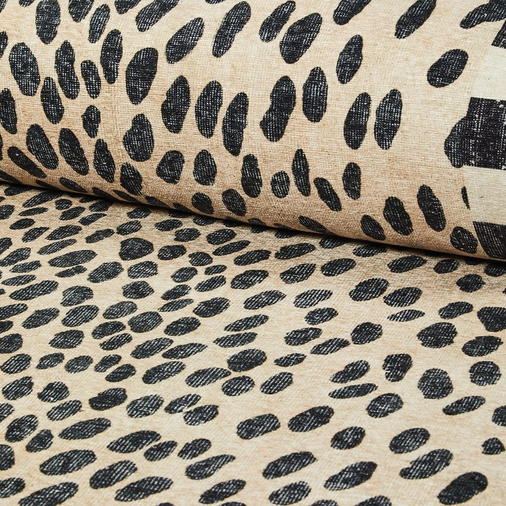 Washable polyester rug with snow leopard spots and check border pattern
