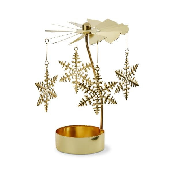 Teal teal iron snowflake carousel holder with gold accents holding a candle.