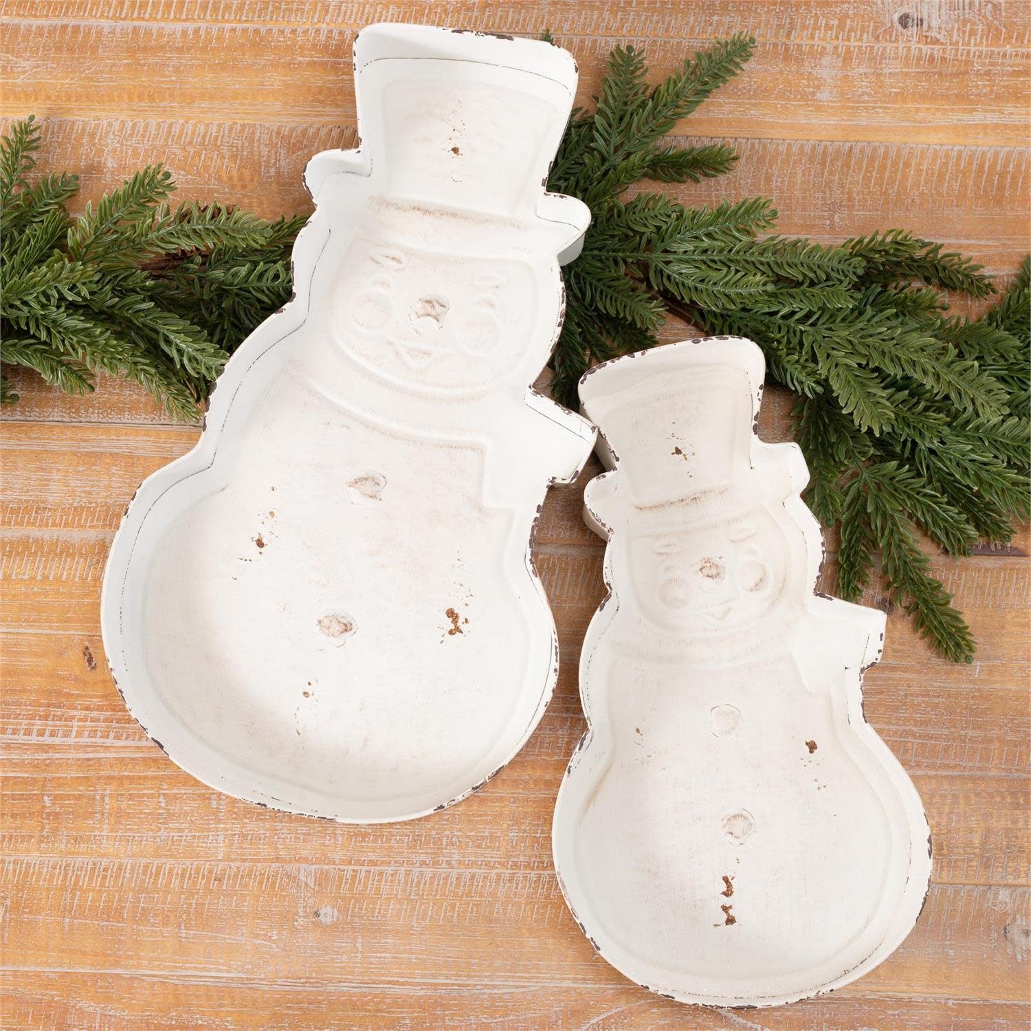 Metal snowman tray with festive white and red holiday design holding treats