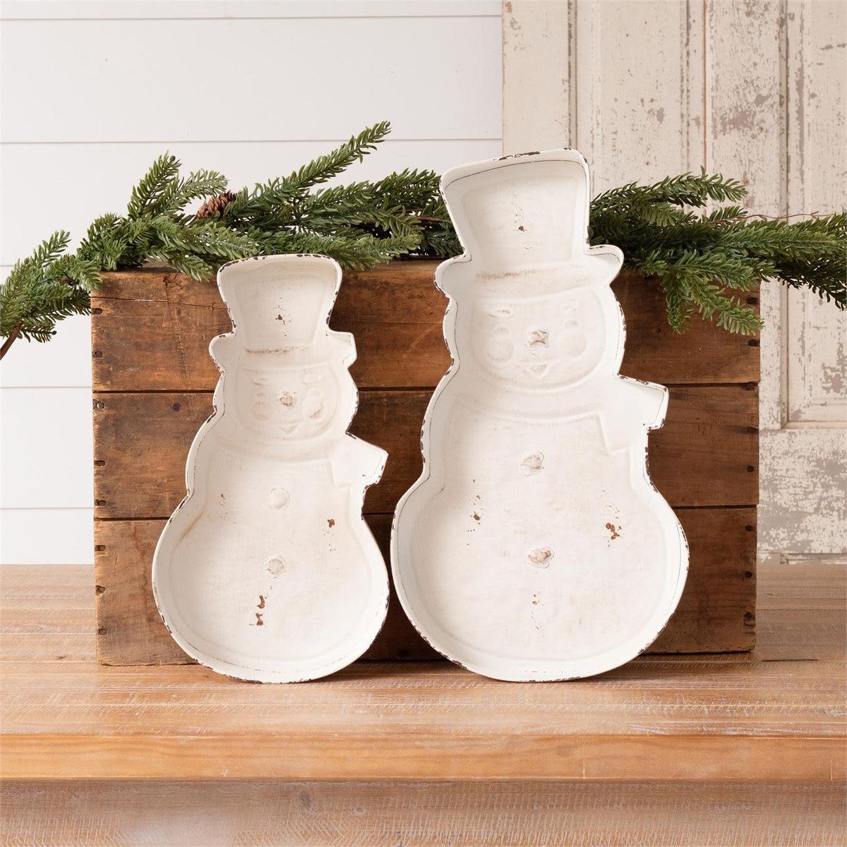 Metal snowman tray with festive white figure design on silver background