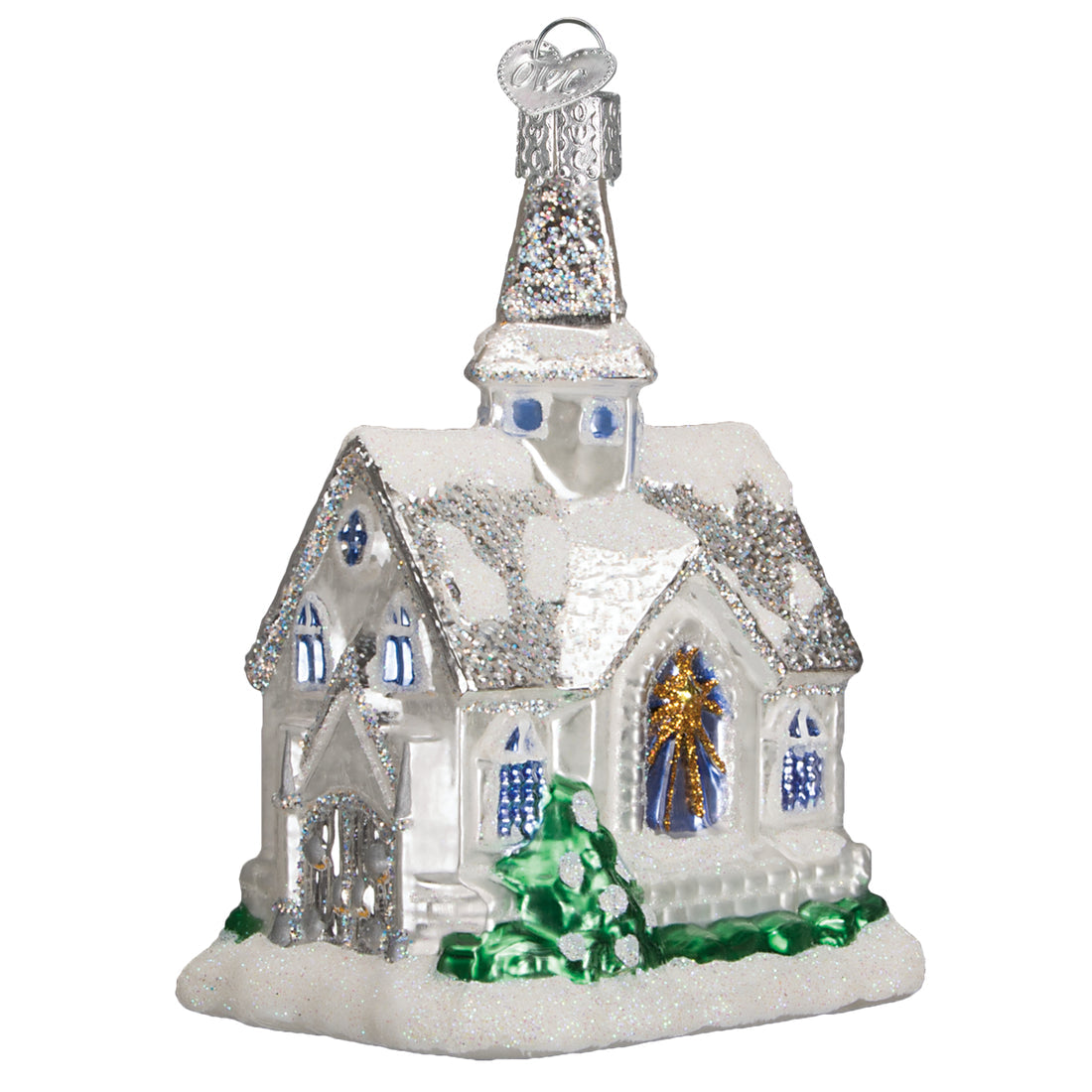 Sparkling glass cathedral ornament with white glitter snow, blue windows, and a green tree detail.