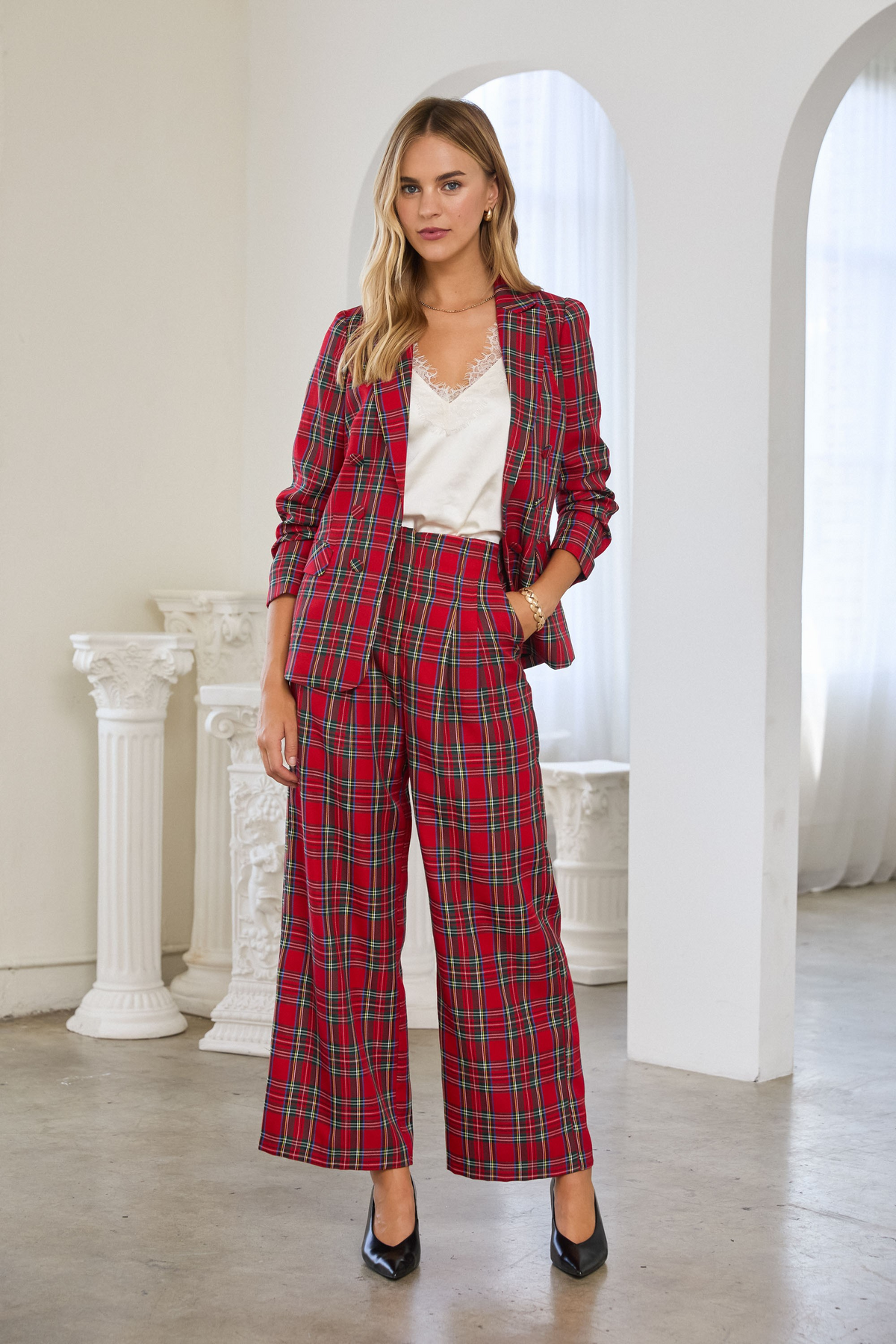 Woman wearing a red Hera Tartan Check Double-Breasted Blazer with matching wide-leg plaid trousers.