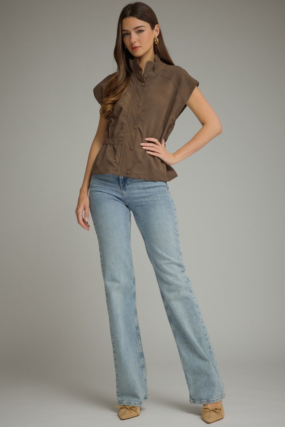 Woman wearing the Sarah Solid Cap Sleeve Jacket in brown with light wash jeans.