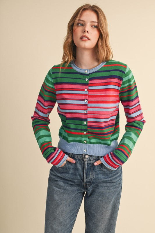 Woman wearing the Vivi multi-color striped sweater cardigan with blue jeans.