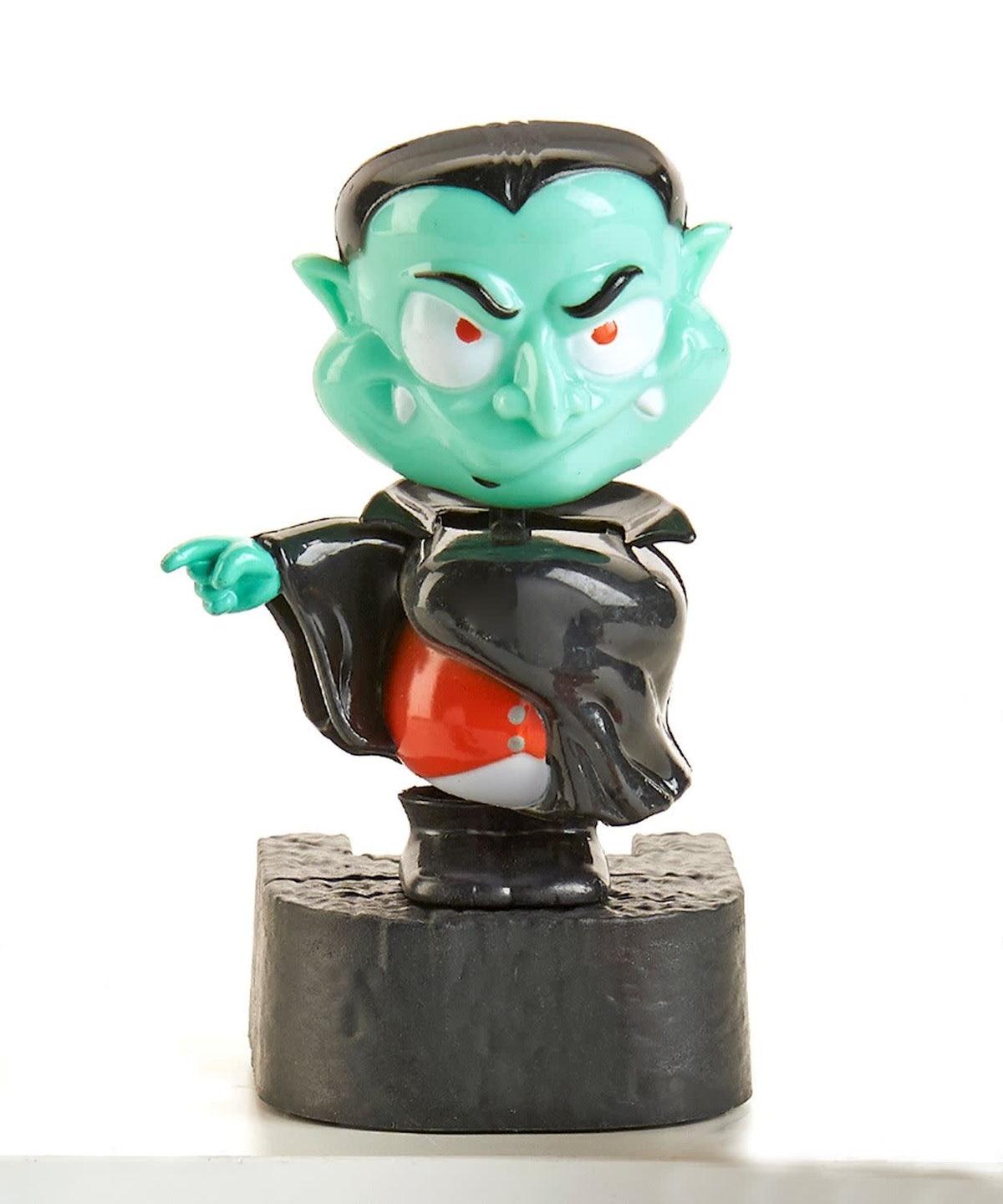 Black vampire figurine with solar dancer pose on window sill