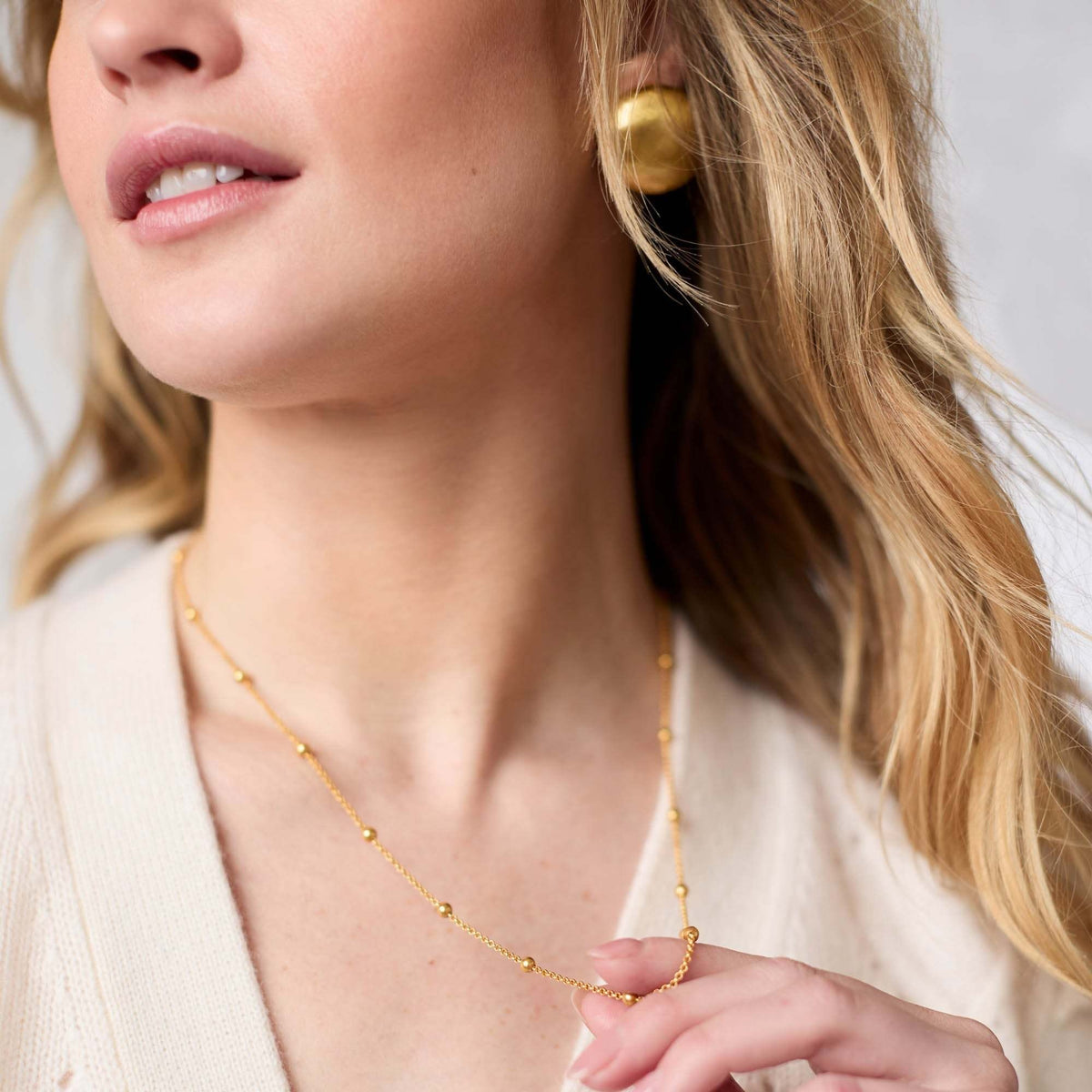 Gold Solara Delicate Station necklace with radiant station charms on a chain.