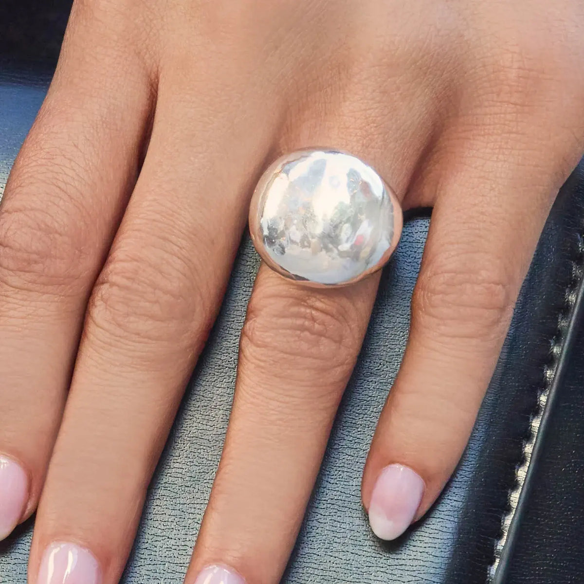 Silver Solara ring with a sleek band featuring a central round gemstone.