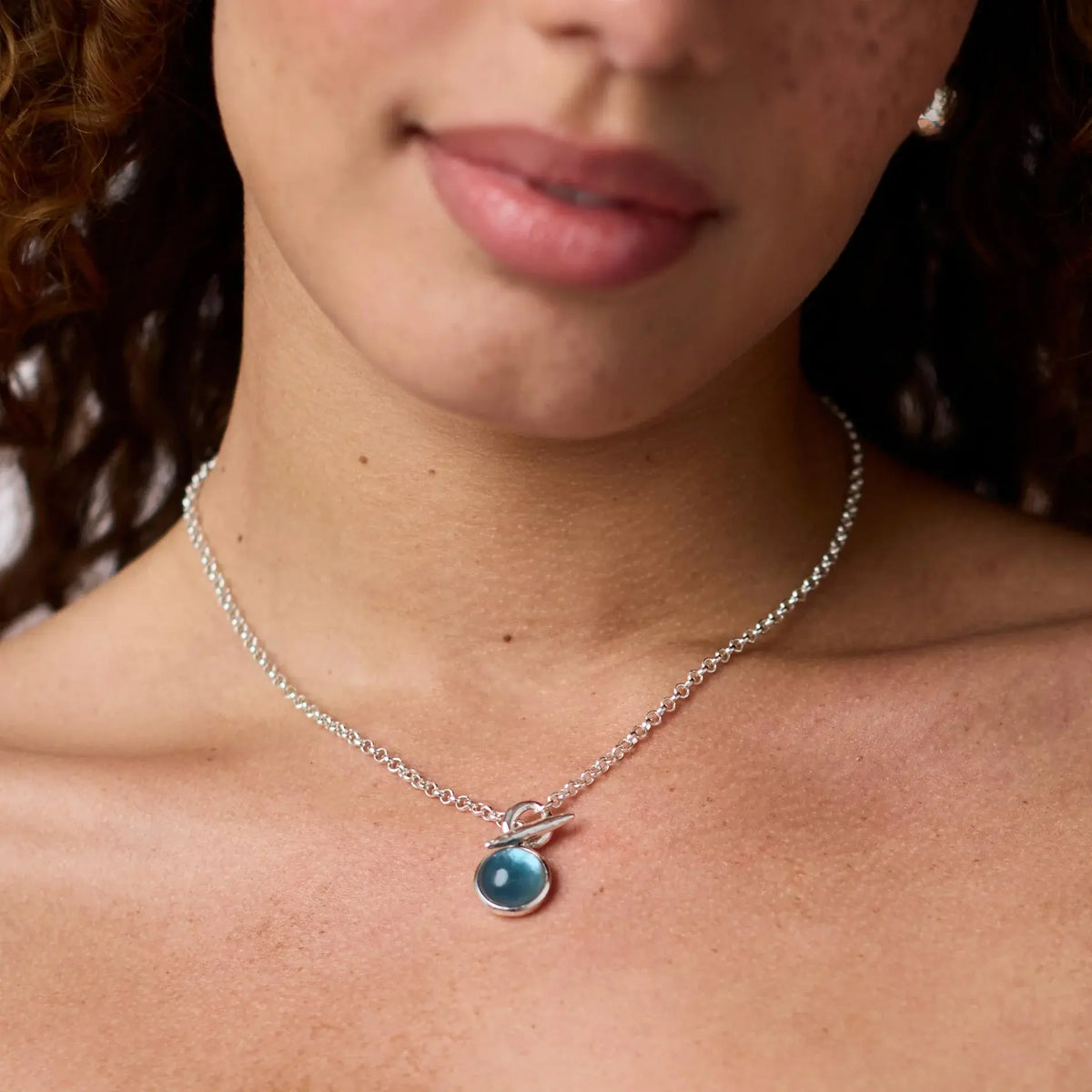 Solara Solitaire necklace with a single sparkling glass pendant on an 18-inch chain.