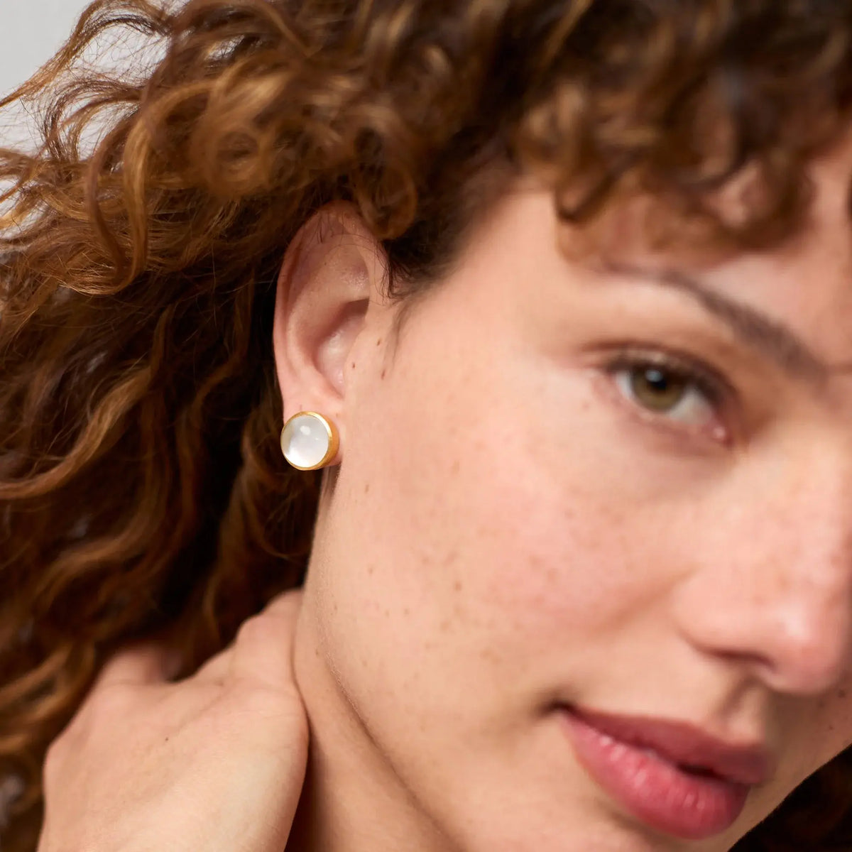 Solara Stone stud earrings in sleek gold with a clear glass stone