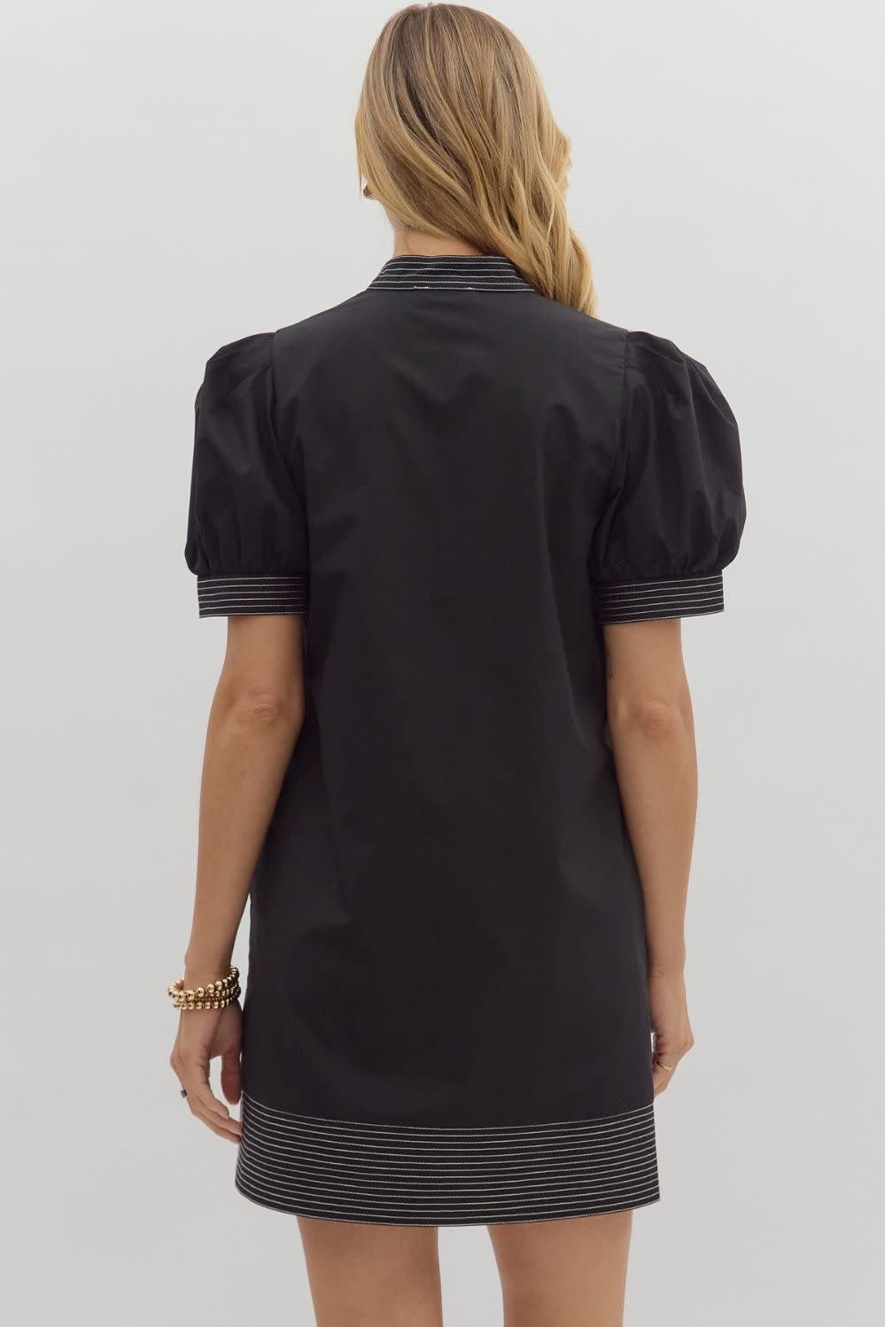 Solid mini dress with puff sleeves, contrast stitch neck band, side pockets, and hem finish.