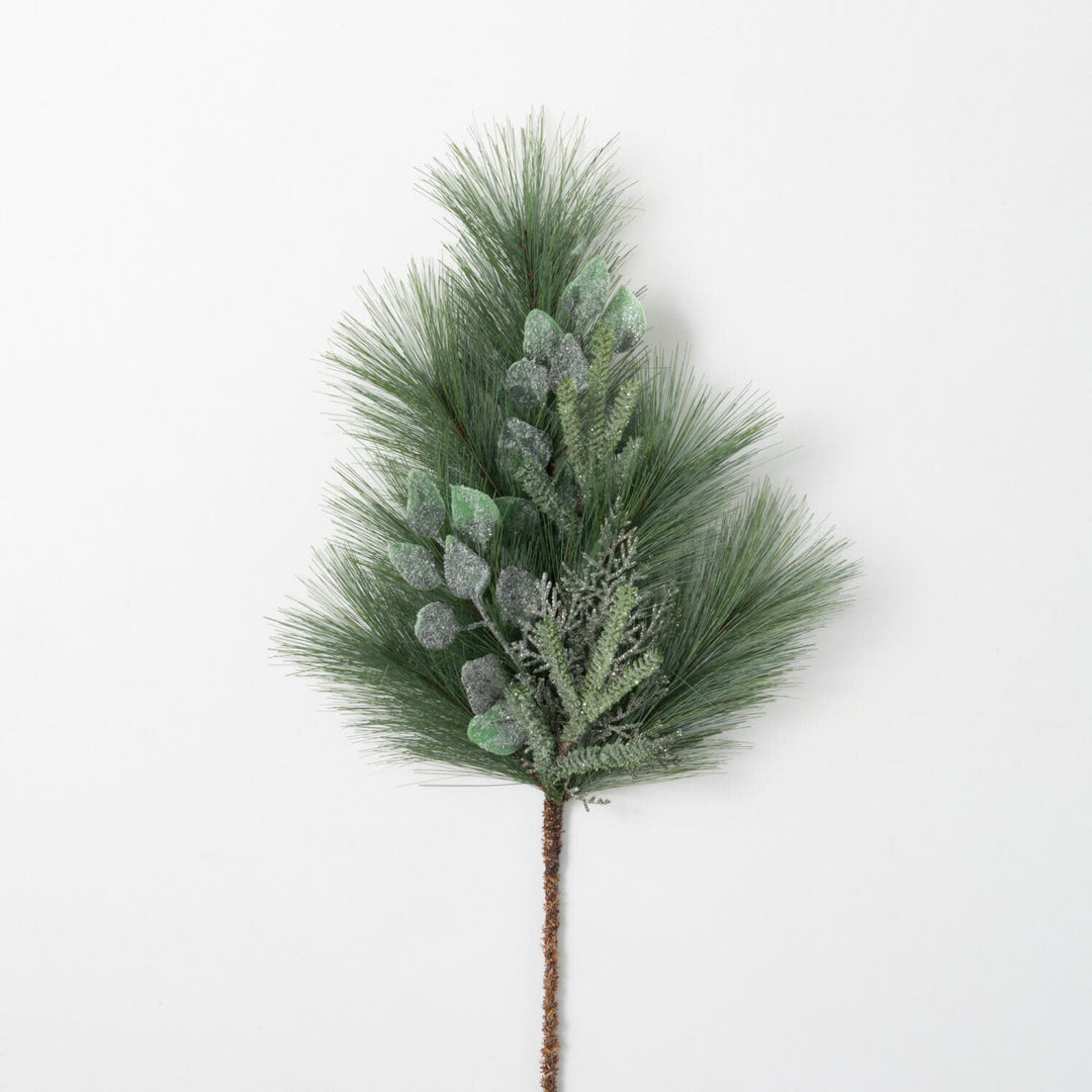 Green plastic artificial pine spray with realistic cones in a warm wintry style.