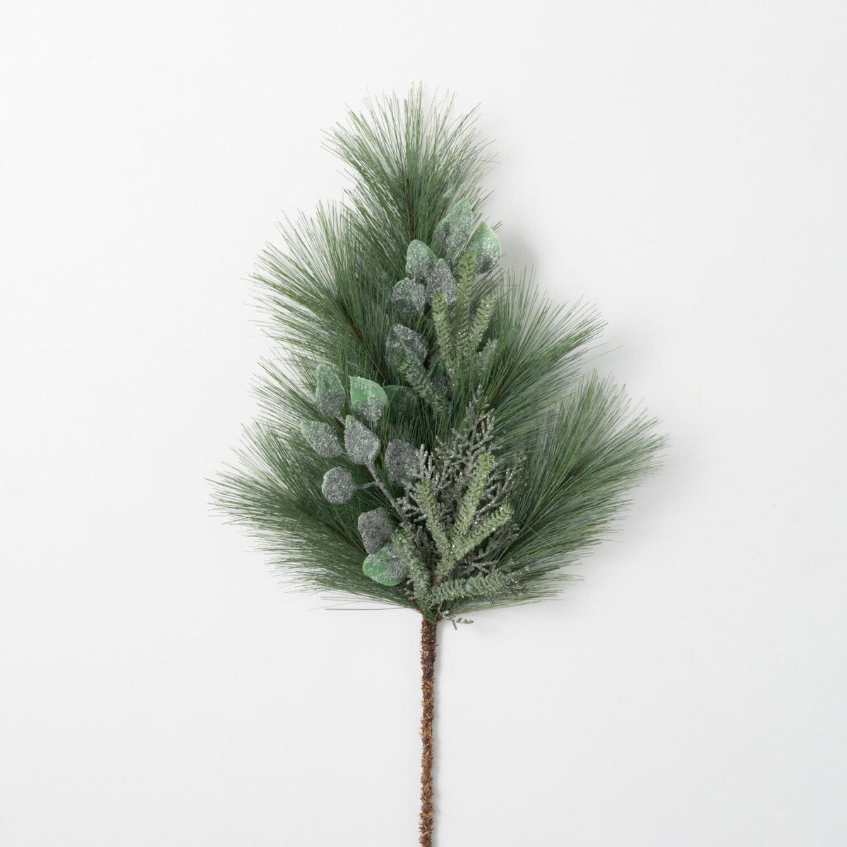 Green plastic artificial pine spray with realistic cones in a warm wintry style.