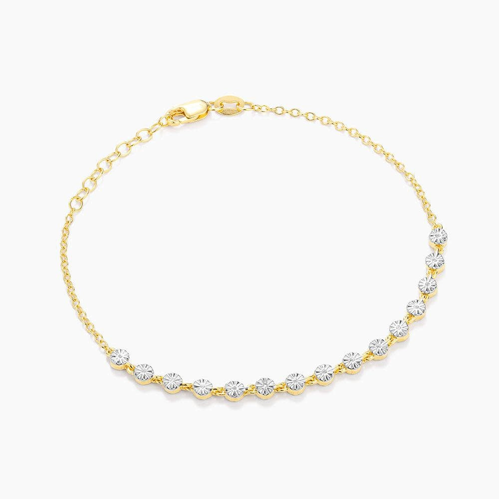 Gold tennis bracelet with diamond accents on a chain featuring lobster clasp closure.