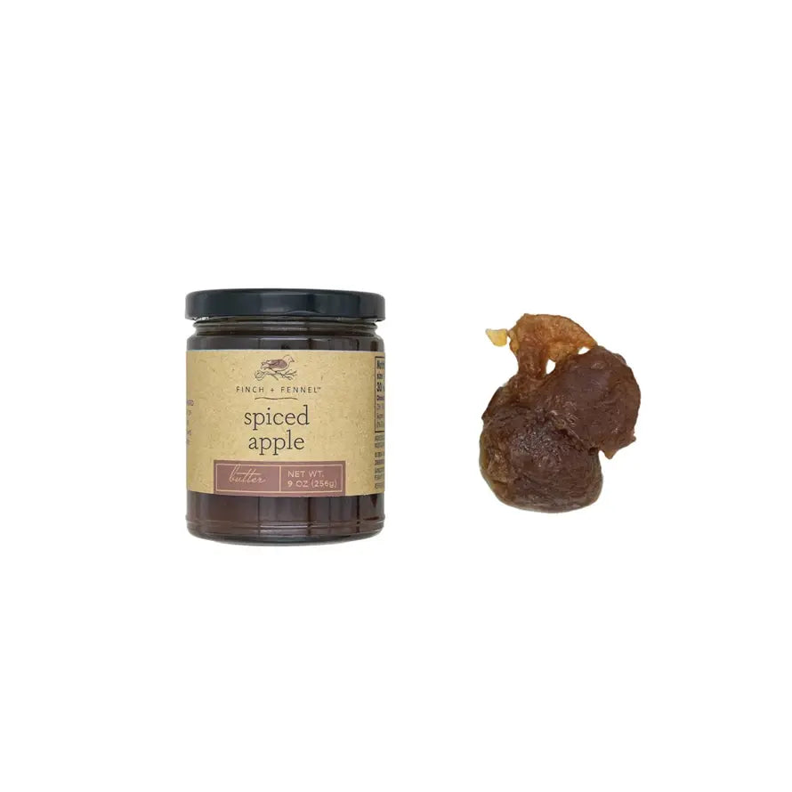 Jar of spiced apple butter with a warm amber color.