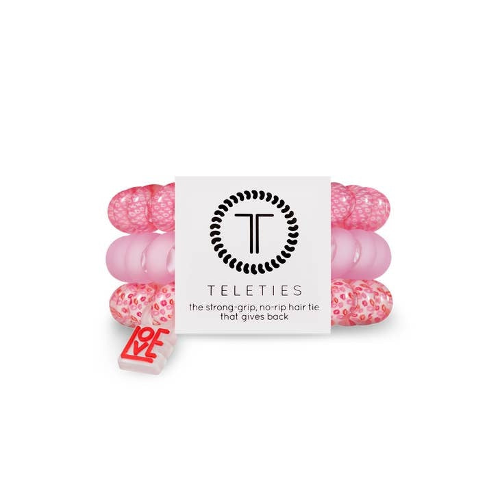 Matte black spiral hair coil tie with a bracelet-style grip.