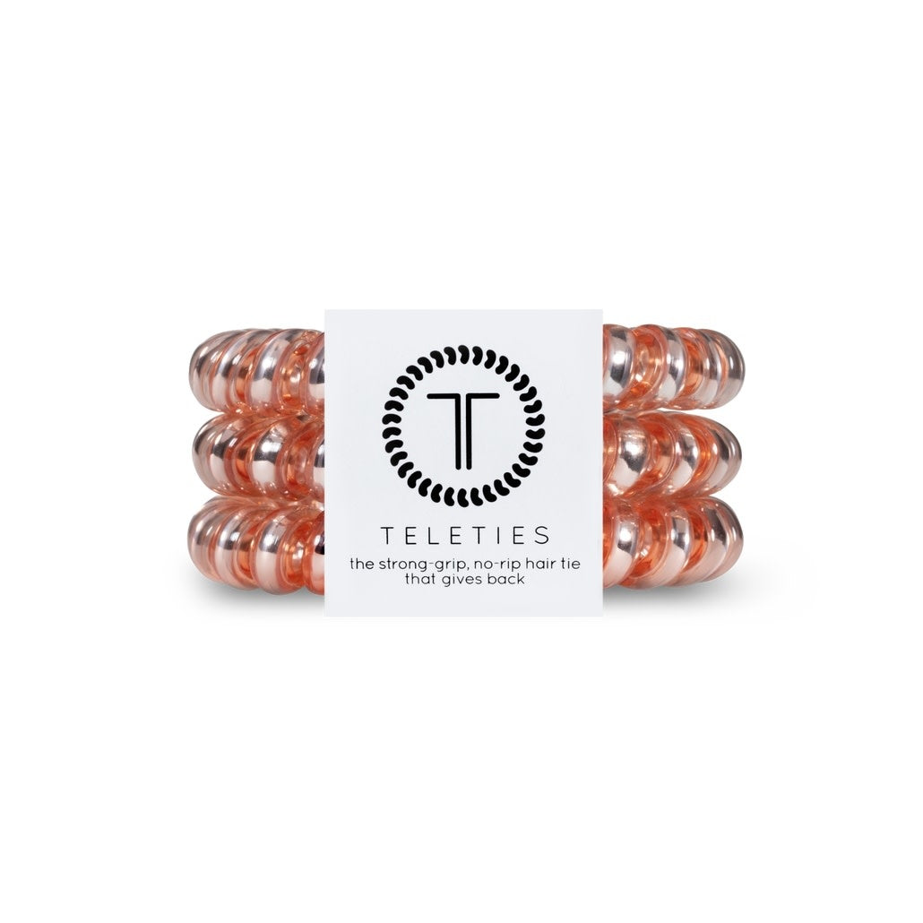 Three millennial pink spiral hair coils with a bracelet-style grip.
